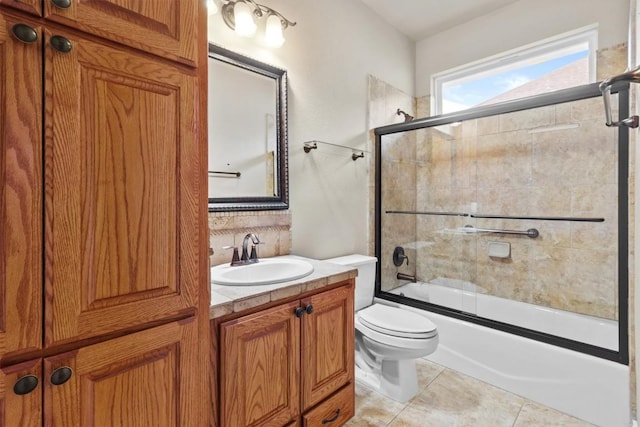 full bath featuring enclosed tub / shower combo, vanity, toilet, and tile patterned floors