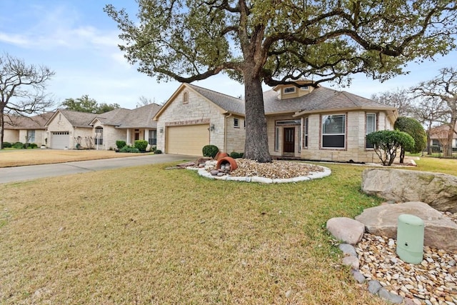 view of front of home featuring a garage, stone siding, driveway, and a front lawn