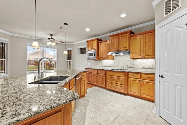 kitchen featuring visible vents, crown molding, appliances with stainless steel finishes, and a sink