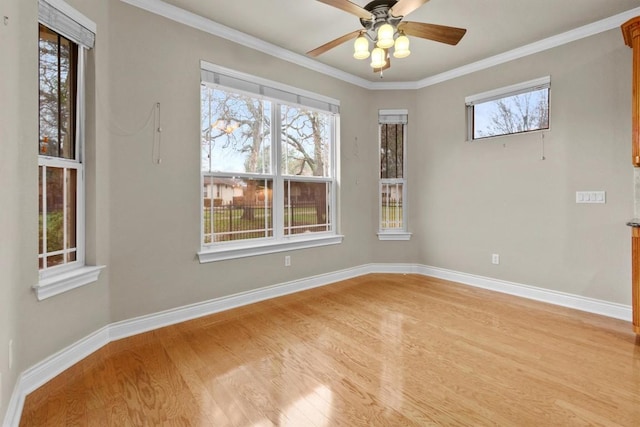 unfurnished room with light wood-style flooring, baseboards, and a wealth of natural light