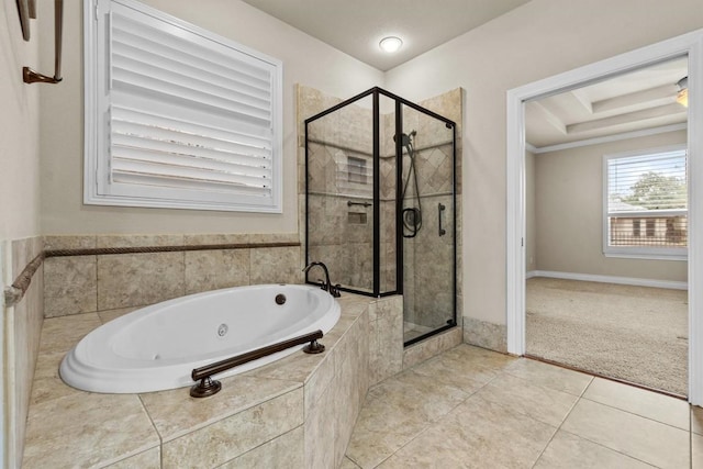 full bath featuring a tray ceiling, a tub with jets, a stall shower, and tile patterned floors