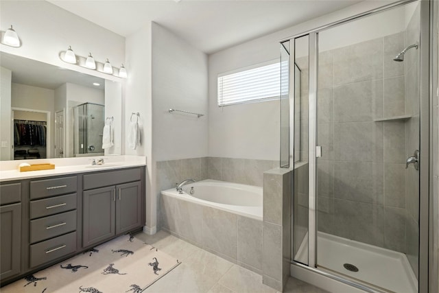 full bath with a stall shower, a spacious closet, vanity, and a bath