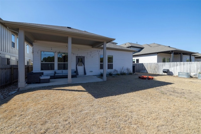 rear view of house featuring a fenced backyard and a patio