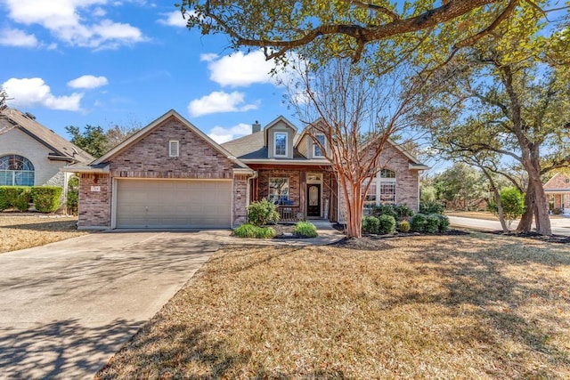 view of front of house featuring driveway, covered porch, an attached garage, and brick siding