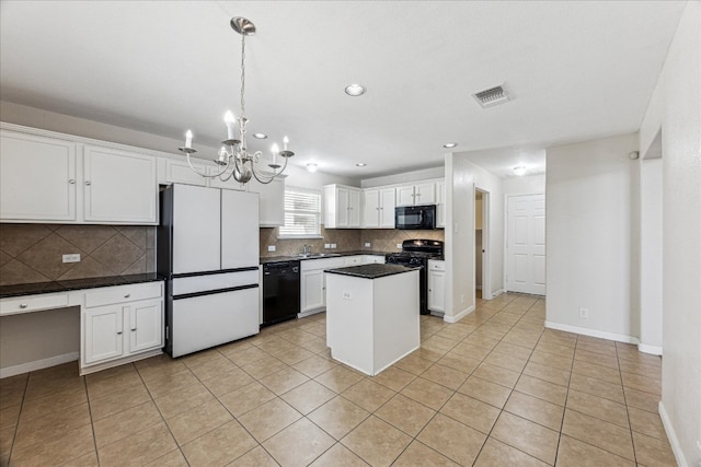 kitchen with a kitchen island, visible vents, white cabinets, black appliances, and dark countertops