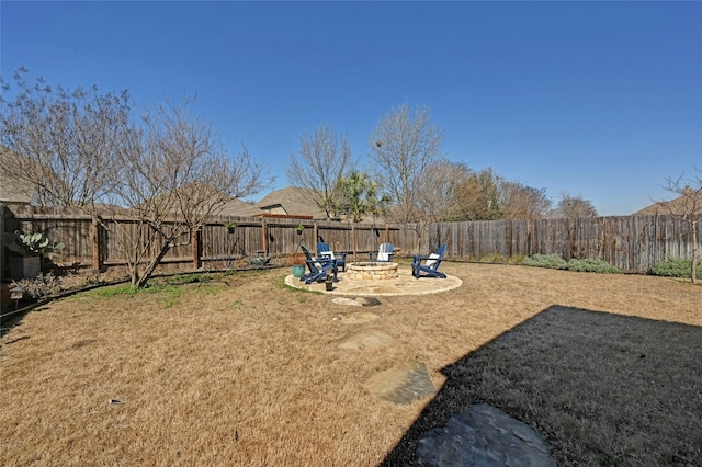 view of yard with a fire pit and a fenced backyard