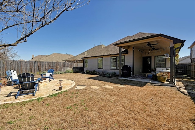 rear view of house featuring a patio area, ceiling fan, an outdoor fire pit, and a fenced backyard