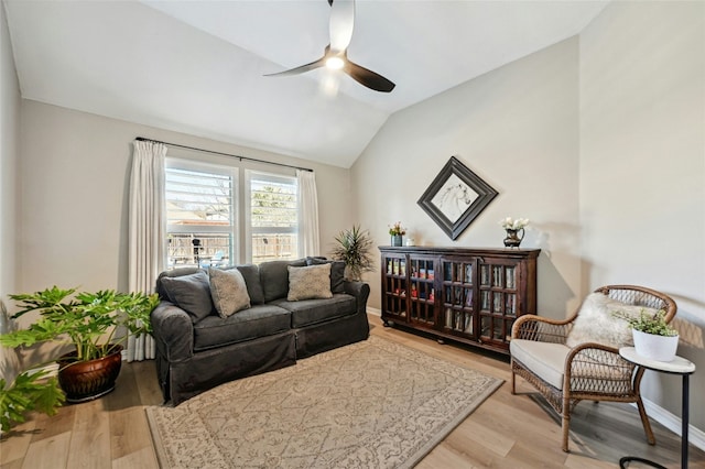 interior space featuring light wood-type flooring, ceiling fan, lofted ceiling, and baseboards