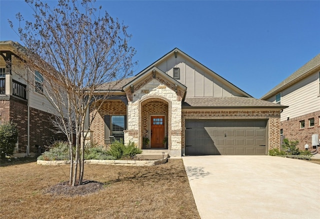 view of front of home with board and batten siding, brick siding, driveway, and a garage