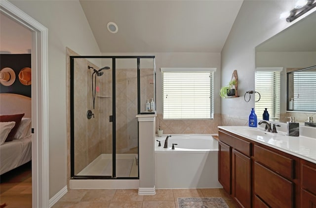 bathroom with lofted ceiling, a garden tub, vanity, and ensuite bathroom