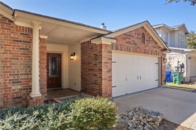 exterior space with a garage, concrete driveway, brick siding, and a chimney