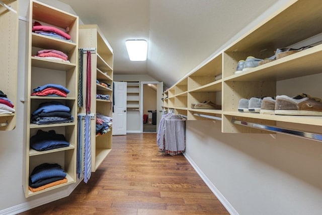 spacious closet with vaulted ceiling and wood finished floors