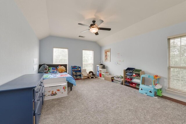 bedroom featuring lofted ceiling, carpet flooring, visible vents, and a ceiling fan