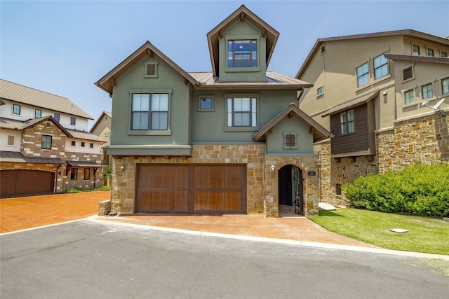 211 Chandler Way, Kingsland, TX 78639 - view of property featuring stucco siding, stone siding, a standing seam roof, metal roof, and driveway