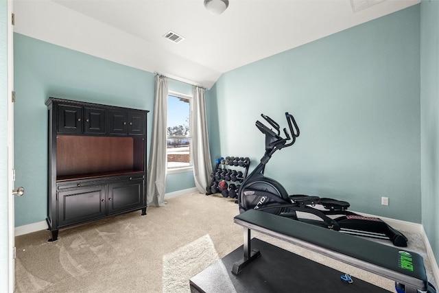 workout room featuring lofted ceiling, baseboards, visible vents, and light colored carpet