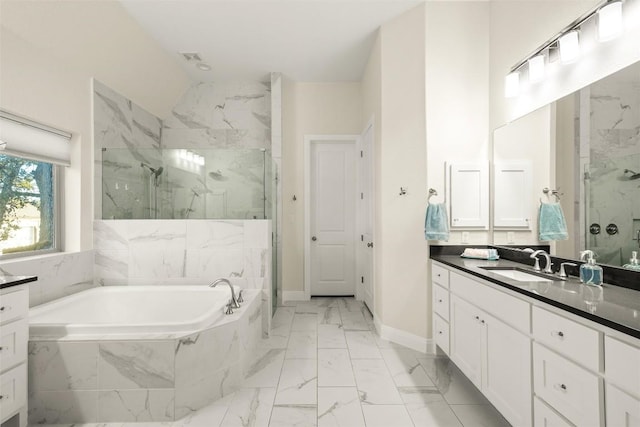 full bath with a garden tub, marble finish floor, a marble finish shower, and vanity