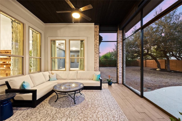 sunroom / solarium with ceiling fan and wood ceiling