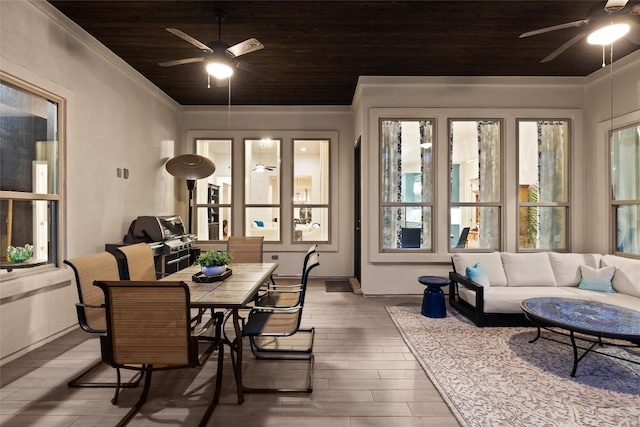 sunroom / solarium featuring wooden ceiling and a ceiling fan