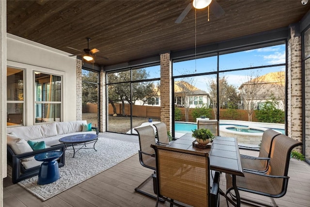 sunroom with wooden ceiling and a ceiling fan