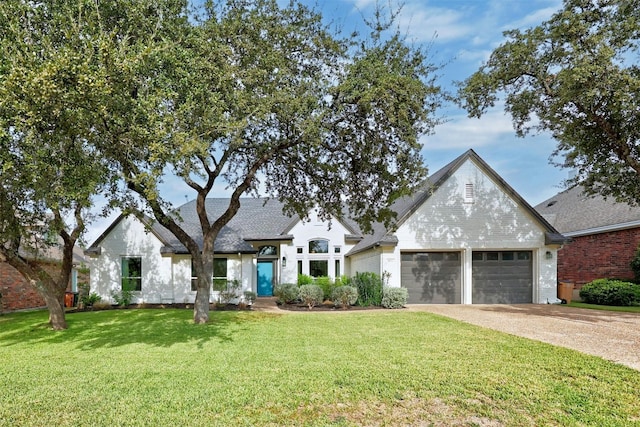 view of front of property with a garage, driveway, and a front lawn