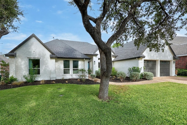 view of front of home featuring a shingled roof, brick siding, driveway, and a front lawn