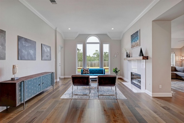 home office with wood-type flooring, ornamental molding, and baseboards