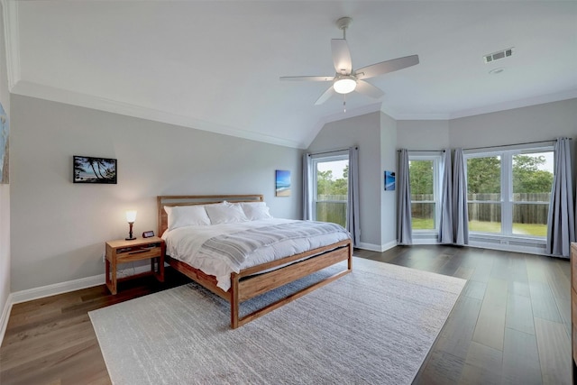 bedroom with dark wood finished floors, visible vents, ornamental molding, a ceiling fan, and baseboards