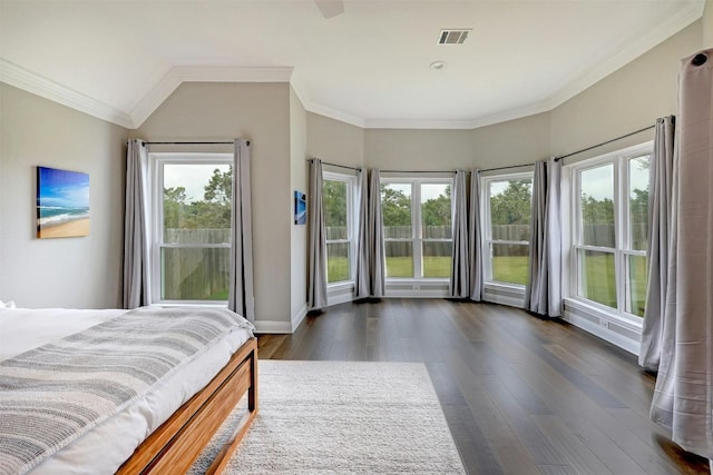 bedroom with dark wood-style floors, ornamental molding, and multiple windows