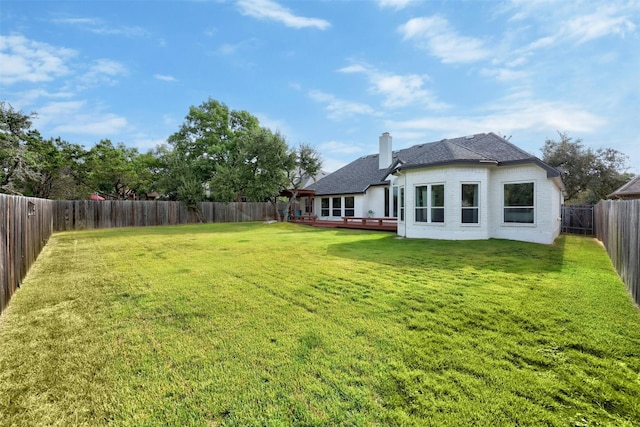 view of yard with a fenced backyard and a deck