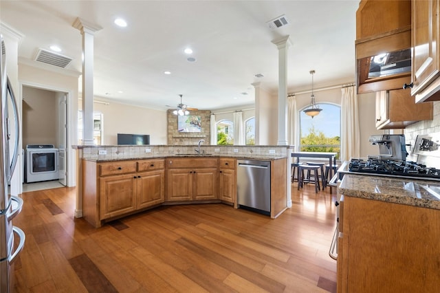 kitchen featuring stainless steel appliances, light stone counters, and visible vents