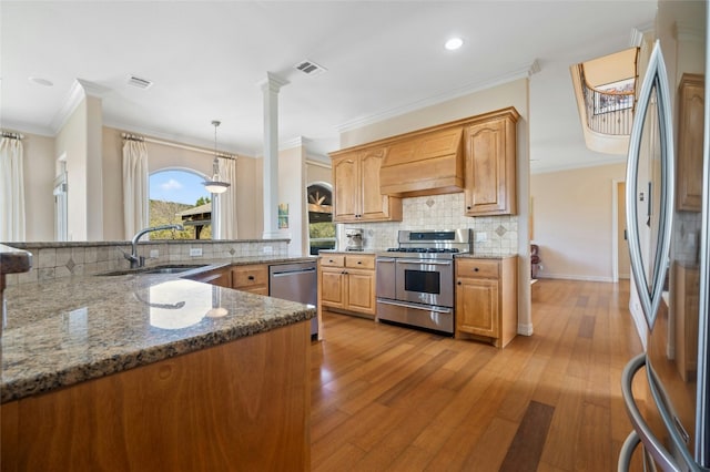 kitchen with custom exhaust hood, visible vents, appliances with stainless steel finishes, and dark stone countertops