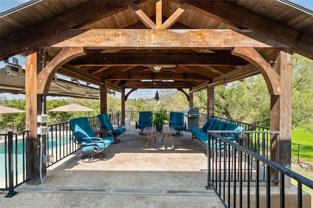 view of patio / terrace with a fenced in pool, area for grilling, fence, and a gazebo