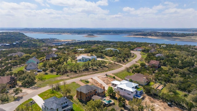 birds eye view of property with a water view and a residential view