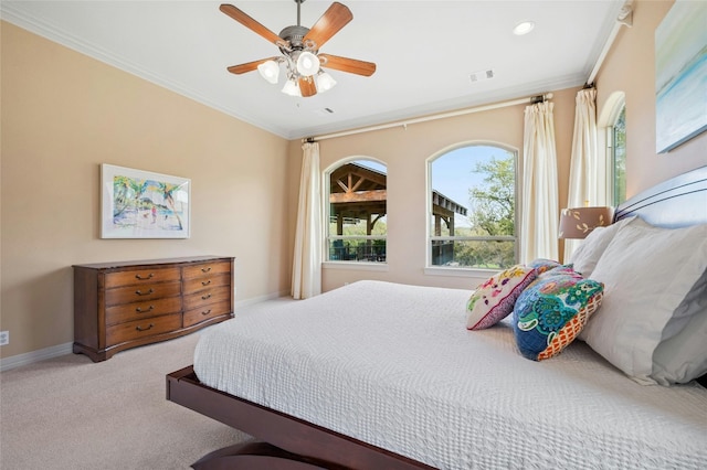 carpeted bedroom featuring crown molding, recessed lighting, visible vents, a ceiling fan, and baseboards