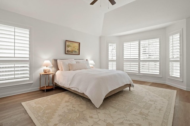 bedroom featuring baseboards, a ceiling fan, vaulted ceiling, and wood finished floors