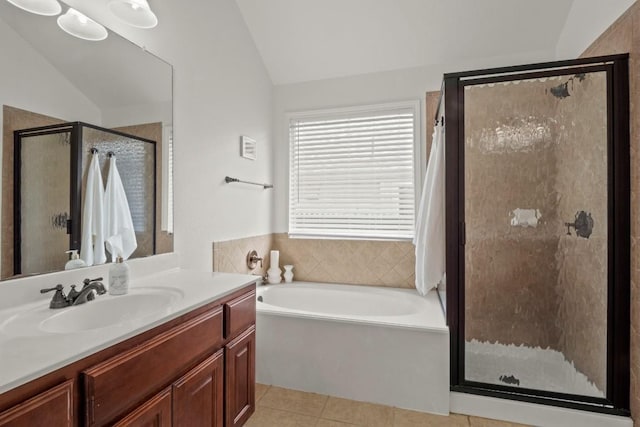 full bath featuring vaulted ceiling, tile patterned flooring, a bath, and a shower stall