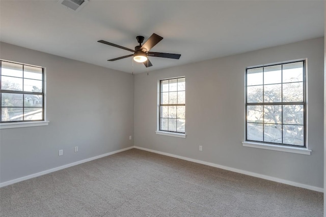 spare room with visible vents, baseboards, carpet, and a ceiling fan