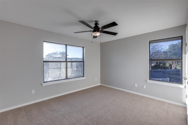 empty room featuring a ceiling fan, carpet flooring, and baseboards