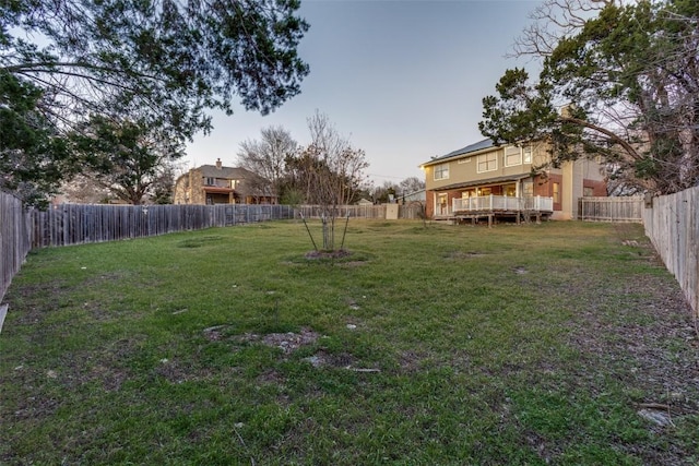 view of yard with a fenced backyard and a wooden deck