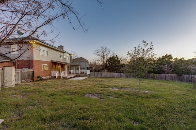 view of yard featuring a fenced backyard and a wooden deck