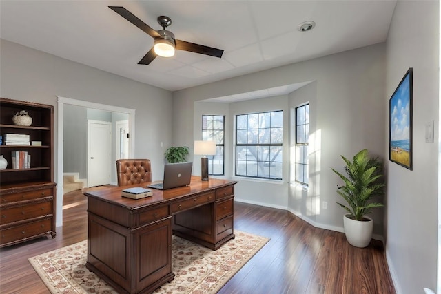 office area with wood finished floors, baseboards, and ceiling fan