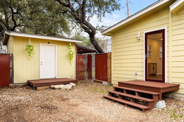 view of outbuilding with an outbuilding and fence