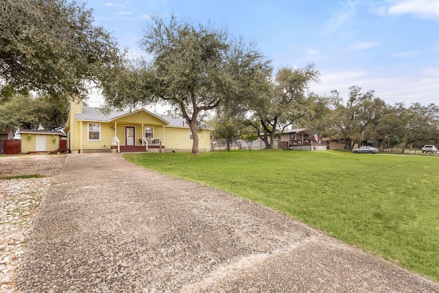 single story home featuring a front yard and driveway