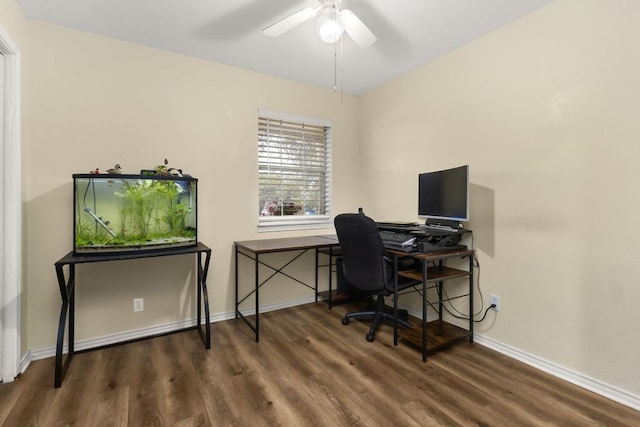 office space with dark wood-style floors, baseboards, and a ceiling fan