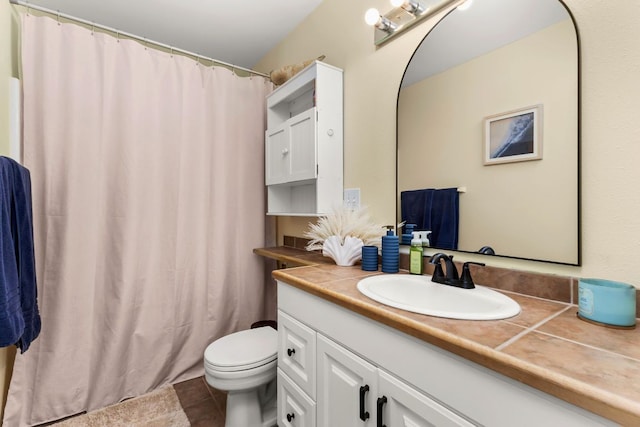 bathroom featuring vanity, toilet, and tile patterned floors
