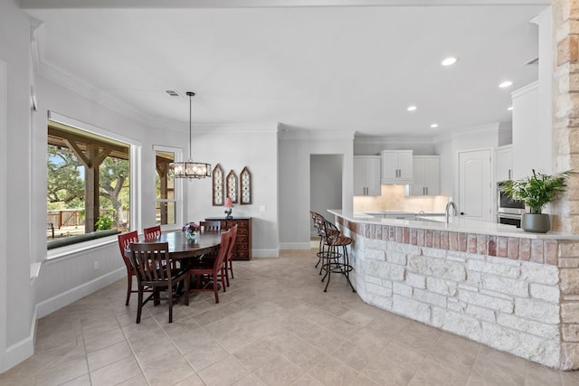 dining area with crown molding, light tile patterned floors, recessed lighting, a chandelier, and baseboards