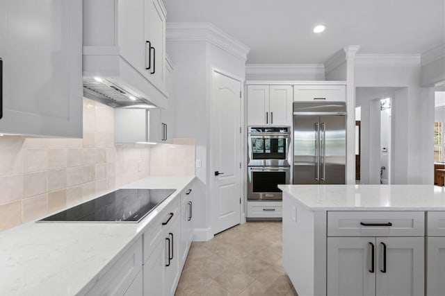 kitchen featuring white cabinetry, light stone counters, and stainless steel appliances