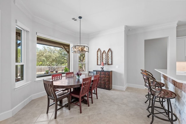 dining space with crown molding, a notable chandelier, and baseboards