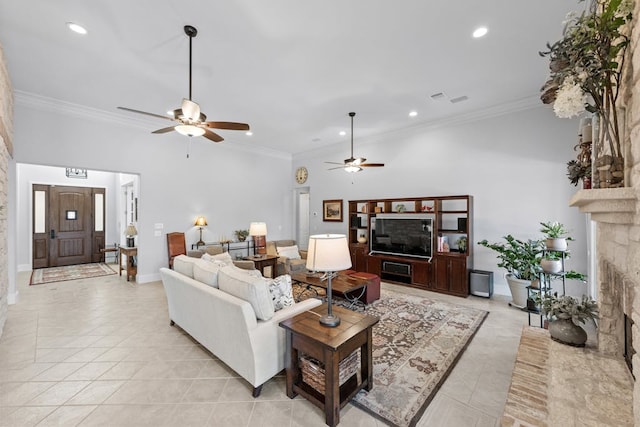 living room featuring ornamental molding, a stone fireplace, light tile patterned floors, and recessed lighting