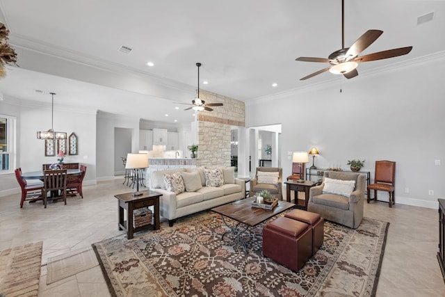 living room with ornamental molding, visible vents, and baseboards